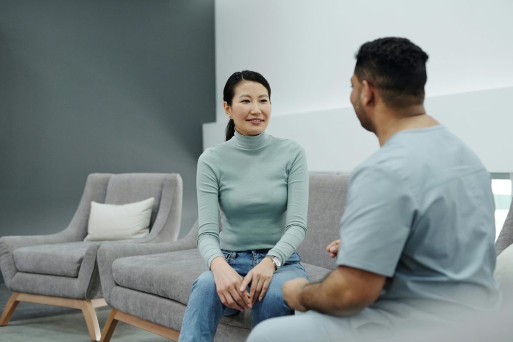 A doctor and patient having a friendly conversation in a modern clinic.